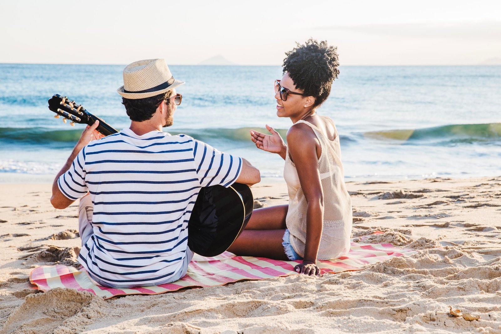 couple-sitting-sand-with-guitar-scaled.jpg